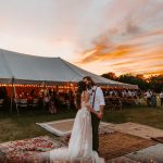 bride and groom dancing at sunset at wedding reception