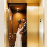 bride and groom in elevator at wedding