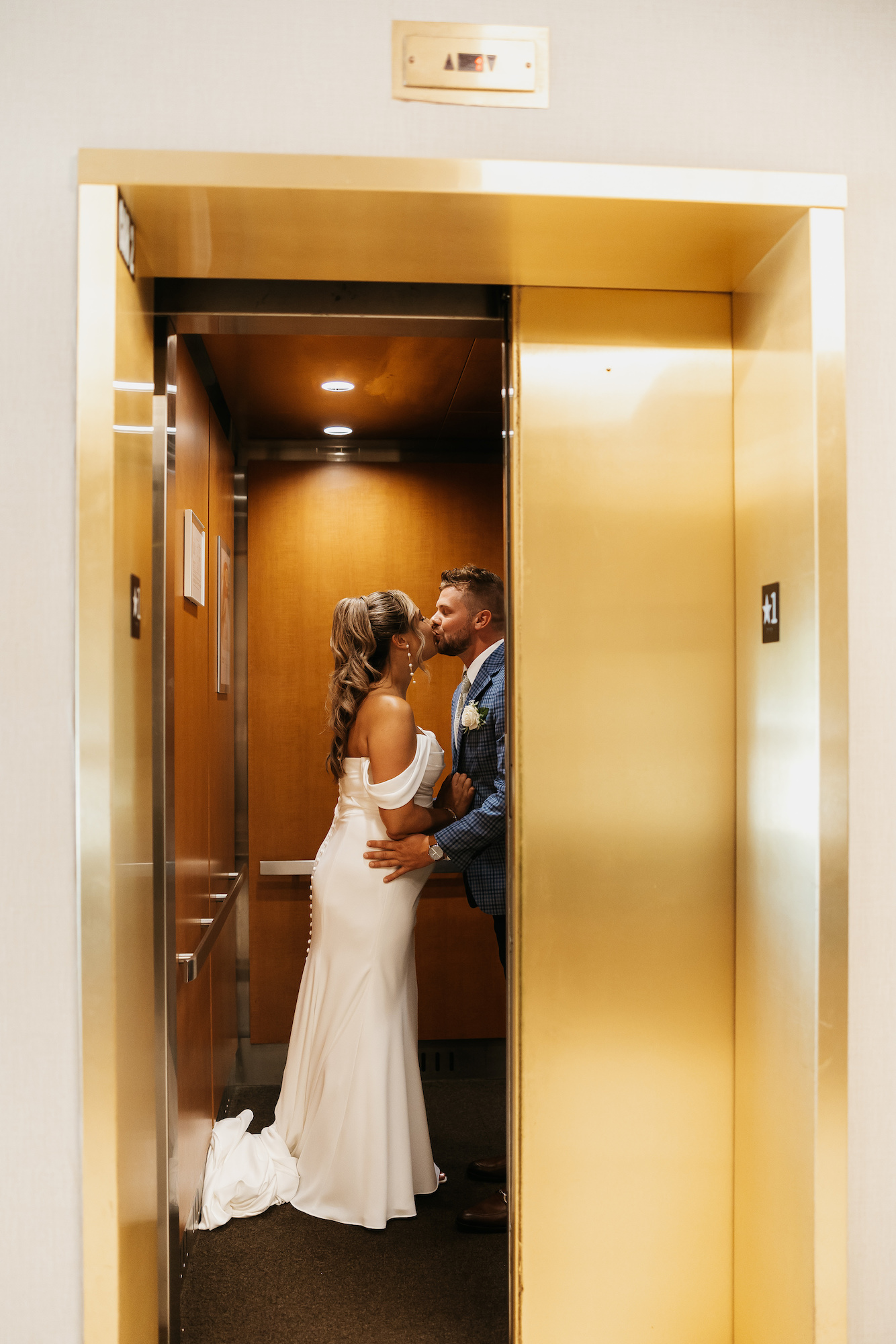 bride and groom in elevator at wedding
