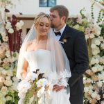 bride and groom with lush florals