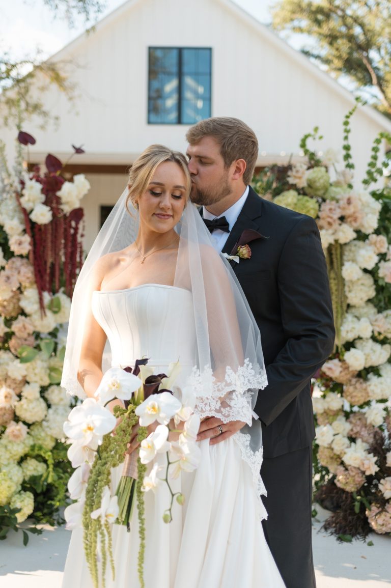bride and groom with lush florals