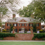 Brantwyn Estate exterior with manicured lawn and garden terrace in Wilmington, Delaware, featured as an all-inclusive wedding venue.