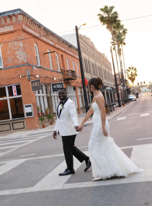 Bride and Groom holding hands in the street of Ybor City