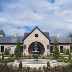 Tuscan-style venue exterior with central fountain and symmetrical towers