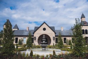 Tuscan-style venue exterior with central fountain and symmetrical towers