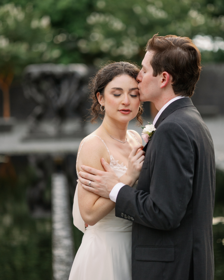 Groom kissing brides head, bride has beautiful soft glam makeup