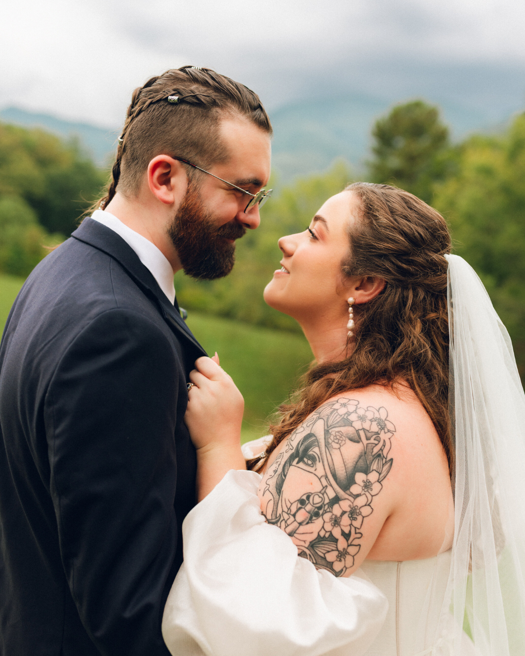 bride and groom looking into eachothers eyes, bride has tattoo on her shoulder