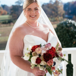 bride with a red and white bouquet with a sweetheart strapless dress line gown