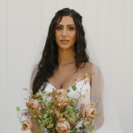 bride with wavy half up half down hair and soft glam makeup