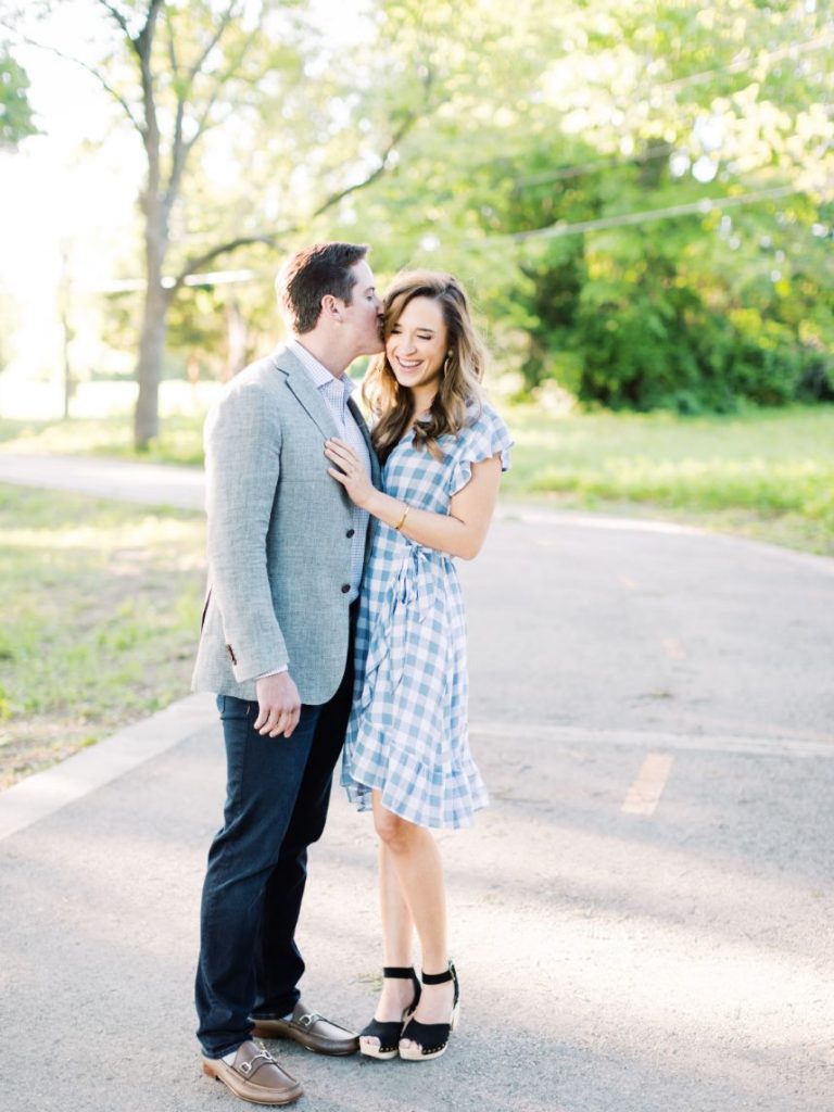couple kissing on road - how to get significant other involved in wedding planning