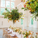 reception in elegant barn setting with orange accents