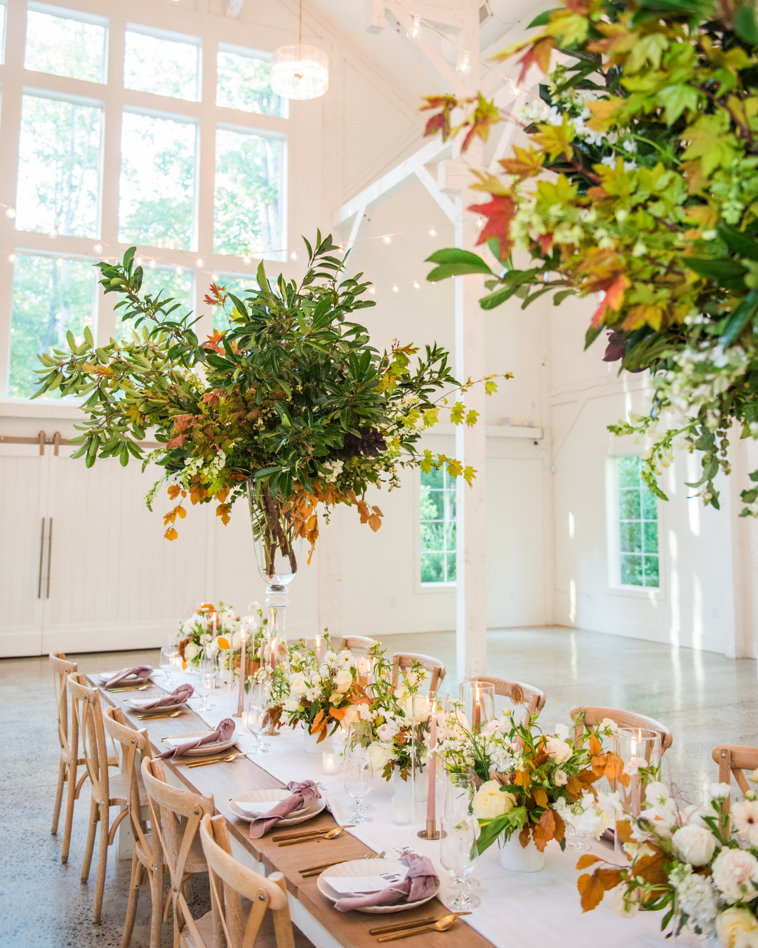reception in elegant barn setting with orange accents