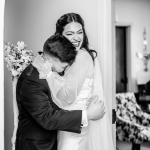 groom reacting to his bride crying