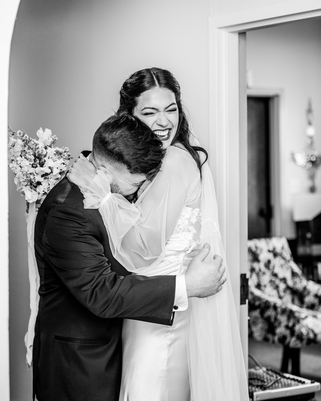 groom reacting to his bride crying
