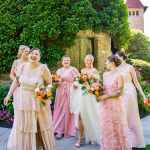 happy bridesmaids in pink dresses walking and laughing with eachother