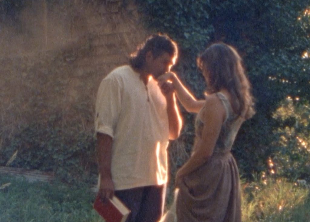 Romantic proposal moment between couple bathed in warm sunlight with sparkling lights