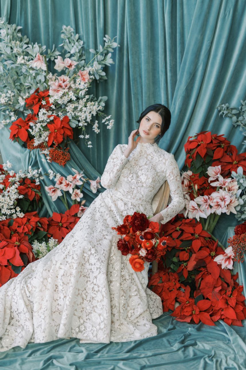 bride surrounded by red flowers