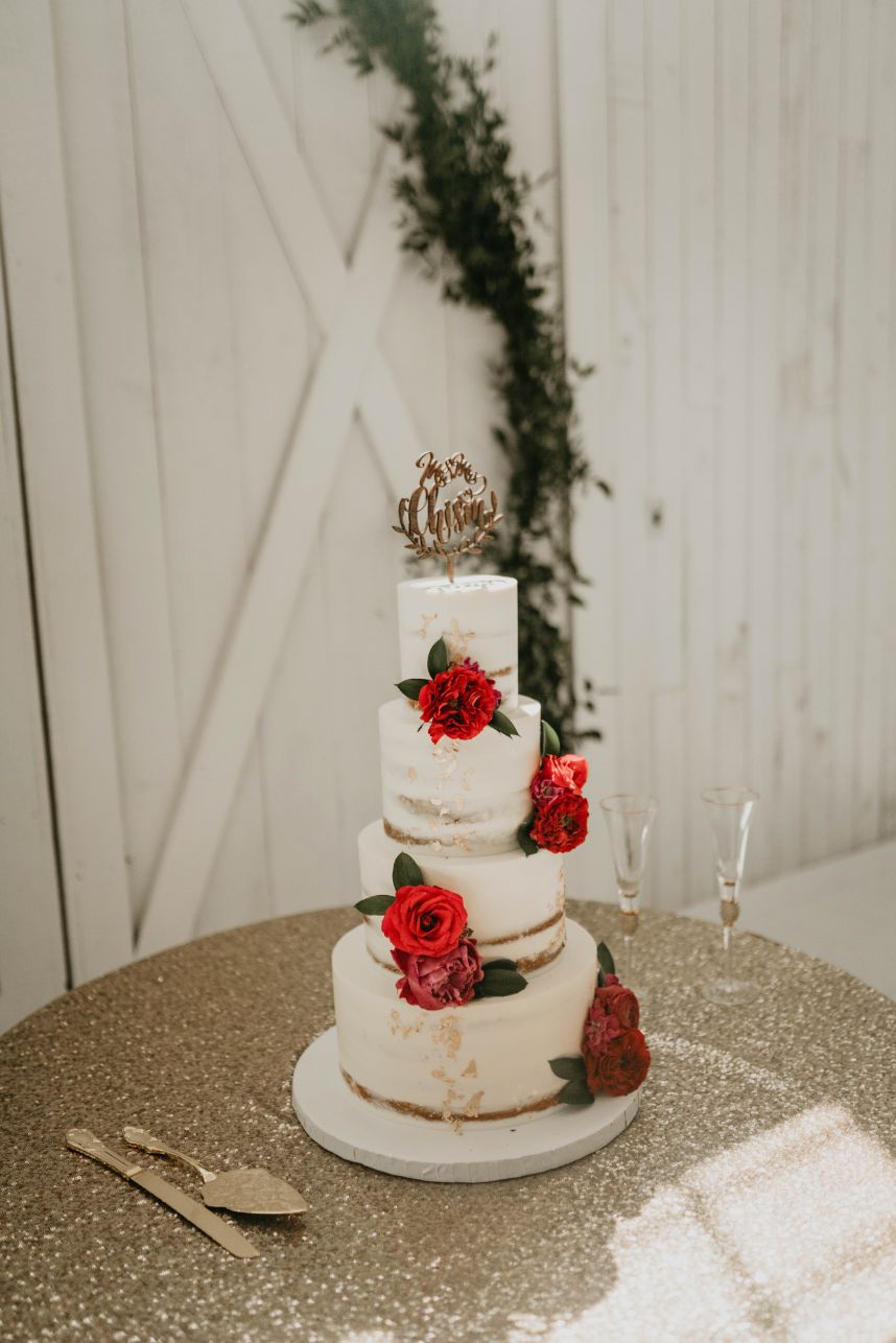 nearly naked cake with red flowers