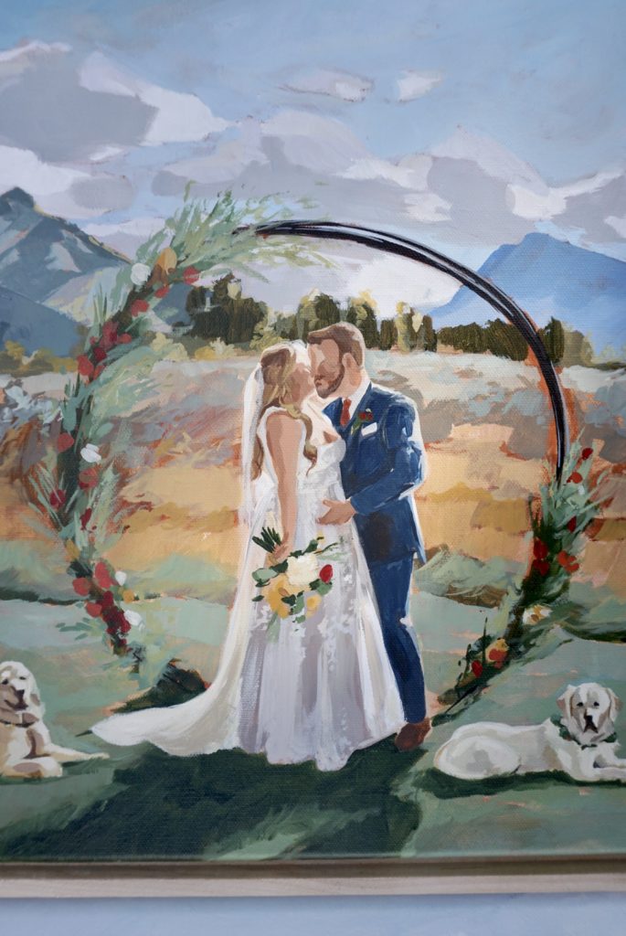 Custom painted wedding portrait featuring couple under floral arch with Colorado mountains and dogs