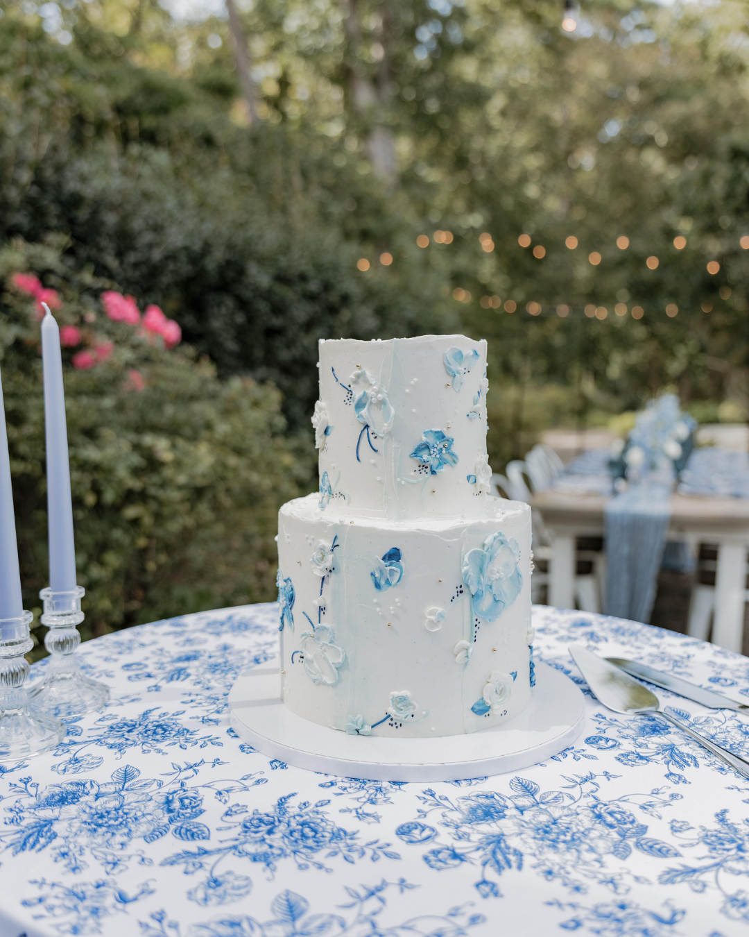 two tiered white wedding cake with blue buttercream accents
