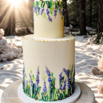 white two tiered wedding cake with blue and green floral accents coming from the bottom and top of the cake