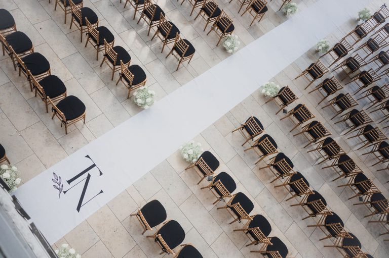 Aerial view of wedding ceremony setup with geometric aisle design and gold chairs