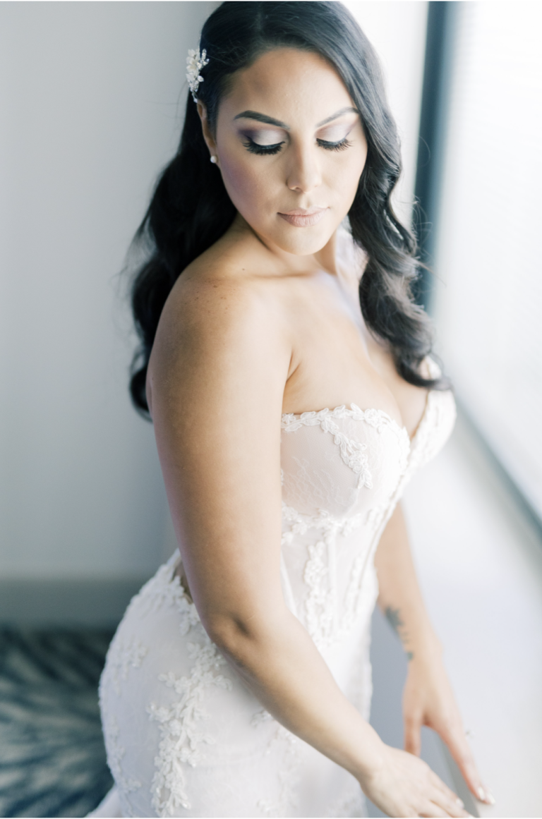 Bride in strapless lace wedding gown with soft, romantic portrait lighting