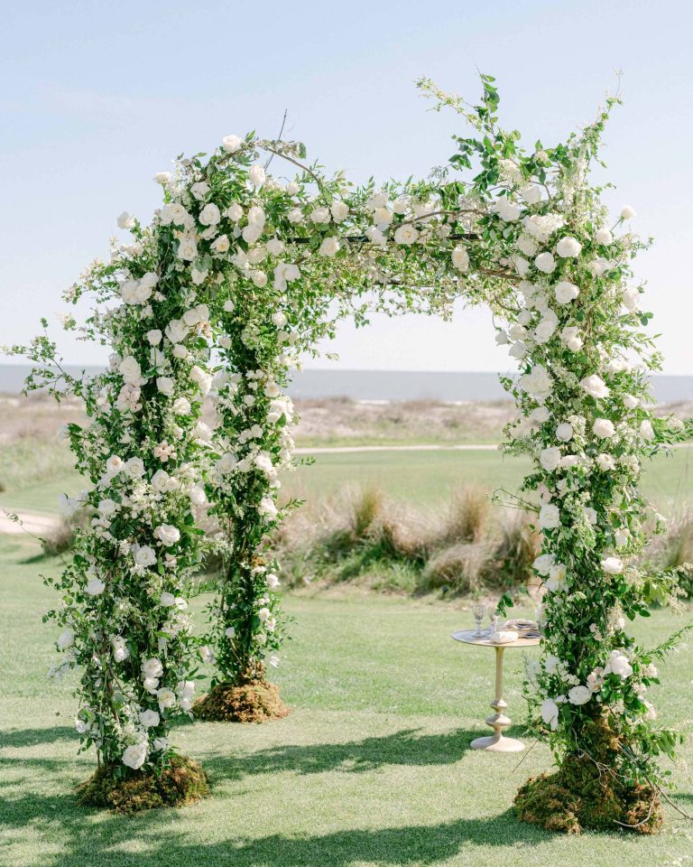 Elegant white rose ceremony arch with lush greenery at Myers Park Country Club autumn wedding