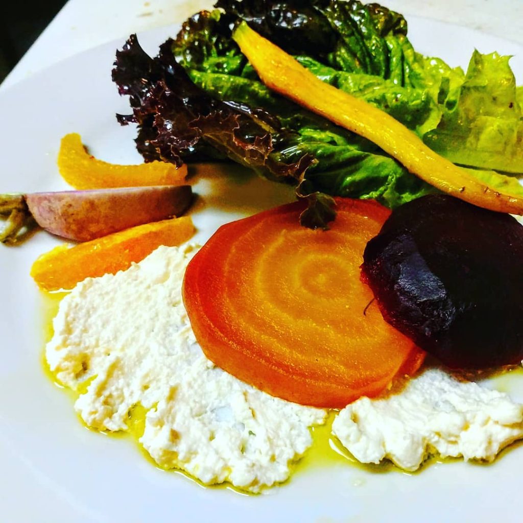 Mixed greens salad with roasted beets, heirloom tomatoes, and goat cheese