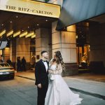 Bride and groom outside The Ritz-Carlton Cleveland entrance at evening