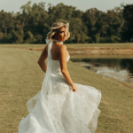 Bride twirling in white wedding dress in coastal Georgia field