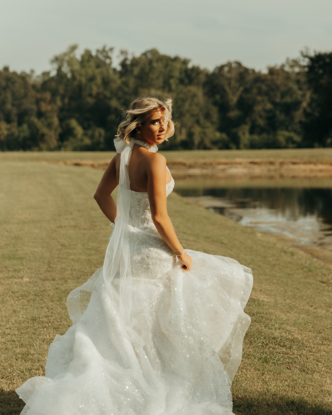 Bride twirling in white wedding dress in coastal Georgia field