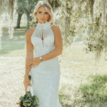 Bride in sequined halter wedding gown holding eucalyptus bouquet beneath Spanish moss-draped oak trees in Savannah