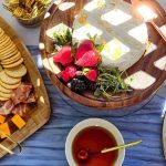 Elegant grazing boards with charcuterie, cheeses, fresh fruits, crackers, and gourmet spreads arranged for wedding catering