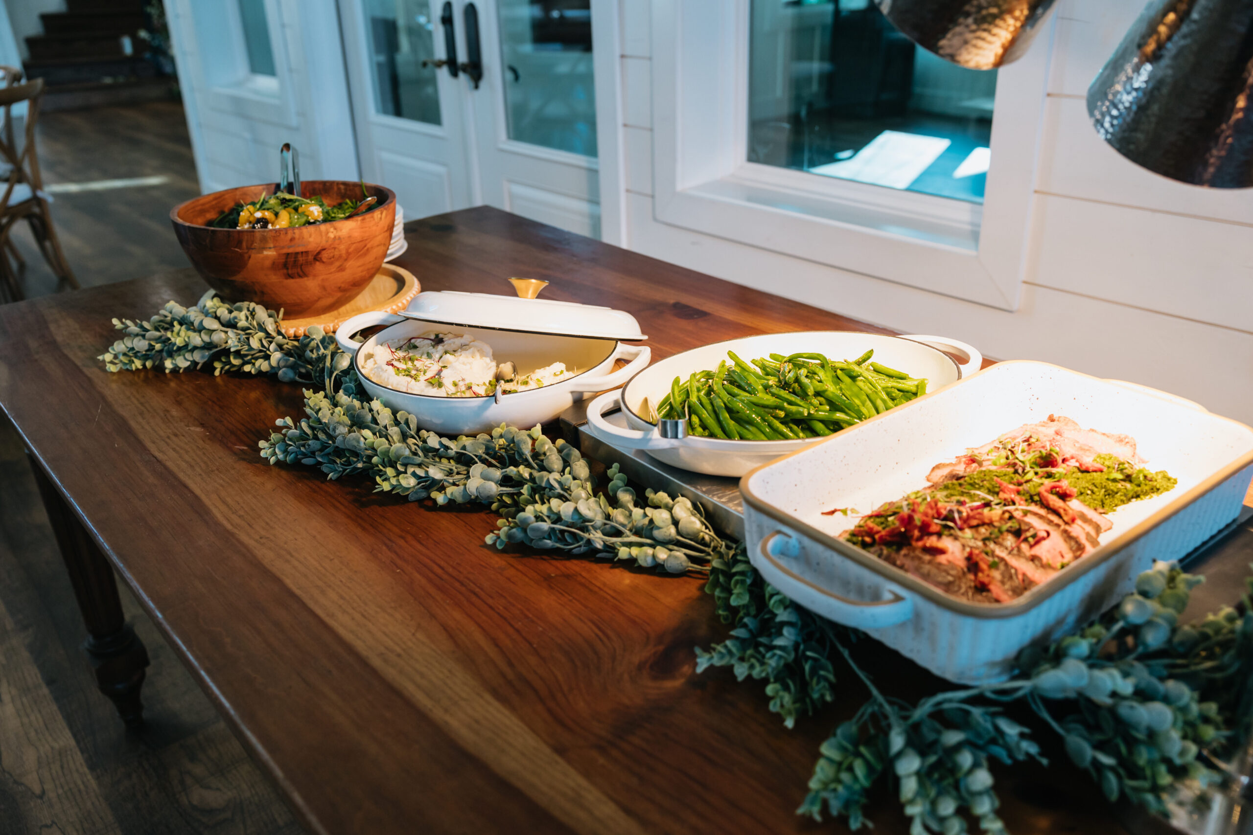buffet of chicken, green beans, and salad beautifully displayed 
