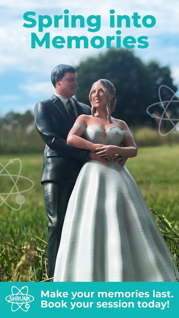 Bride and groom embracing outdoors in grassy field under dramatic cloudy sky