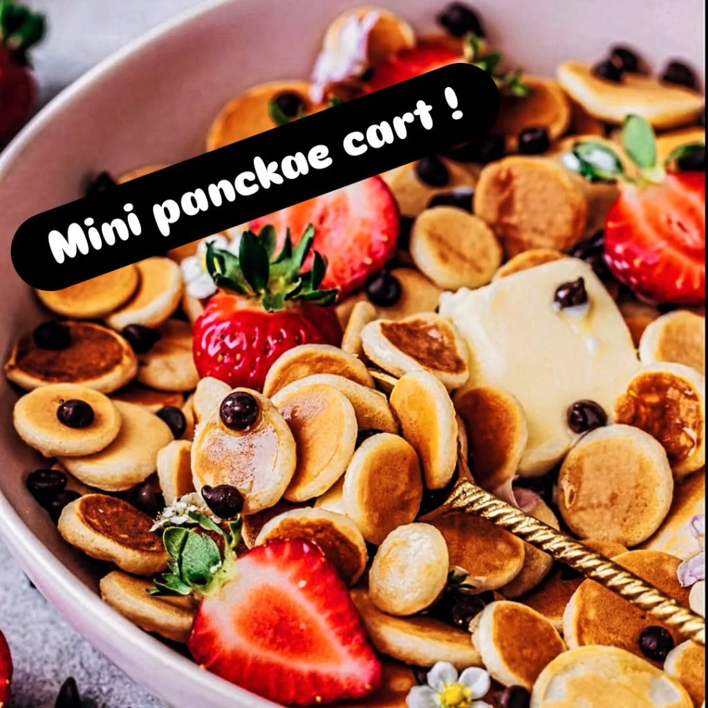 Mini pancake cart display with golden pancakes, fresh berries, and syrup by C'est Deluxe wedding caterers