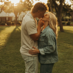 Engaged couple sharing intimate moment outdoors during golden hour photoshoot