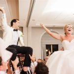 Bride and groom celebrating on chairs during hora dance at Savannah wedding reception