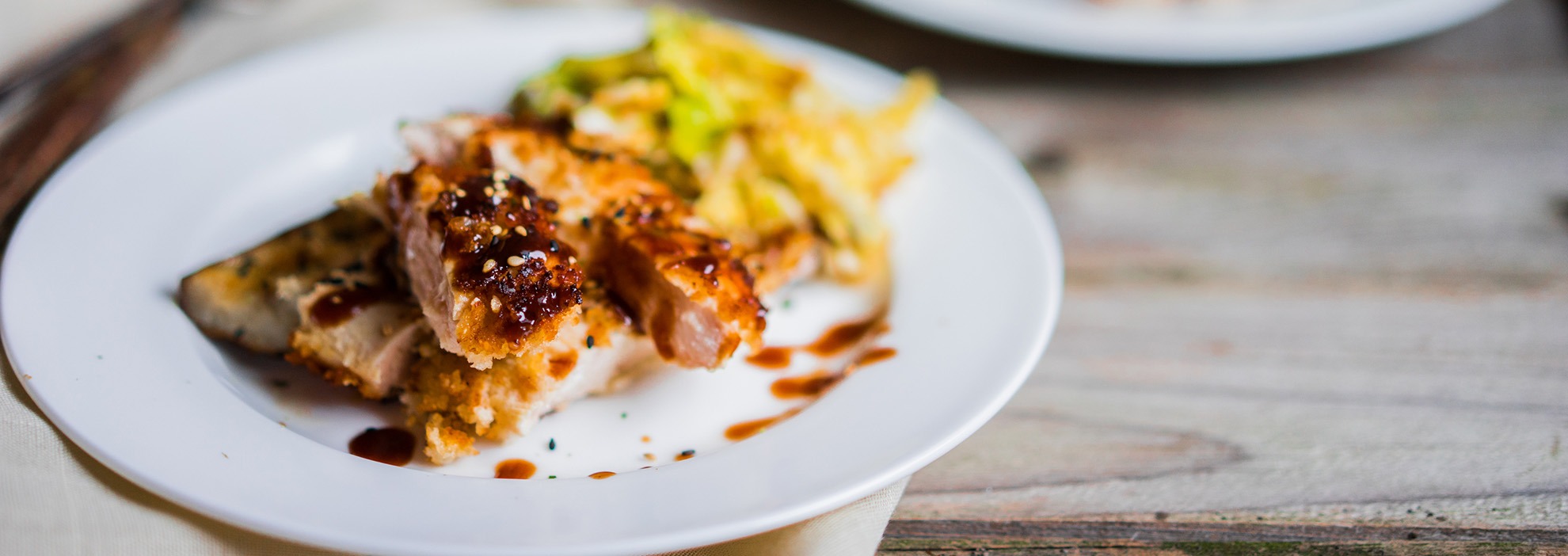 Grilled chicken skewers with vegetables and teriyaki glaze on white plate