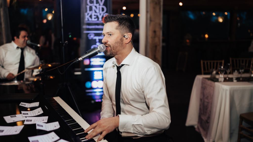 Cleveland Keys pianist performing in white shirt and black tie at wedding reception