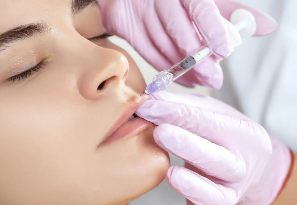 Woman receiving lip filler injection at medspa for bridal beauty preparation