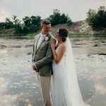 Bride in elegant veil and groom in modern suit at unique Colorado outdoor wedding venue