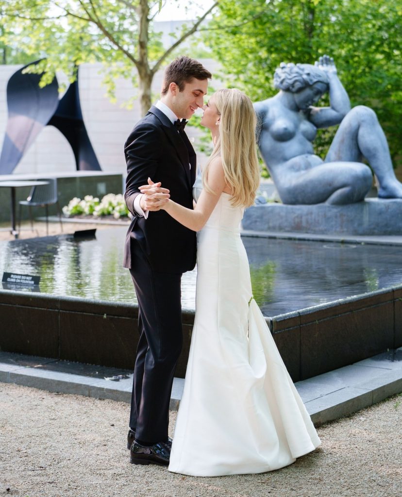 Bride and groom dancing by the reflecting pool in the sculpture garden at the Columbus Museum of Art wedding venue in Columbus, Ohio.