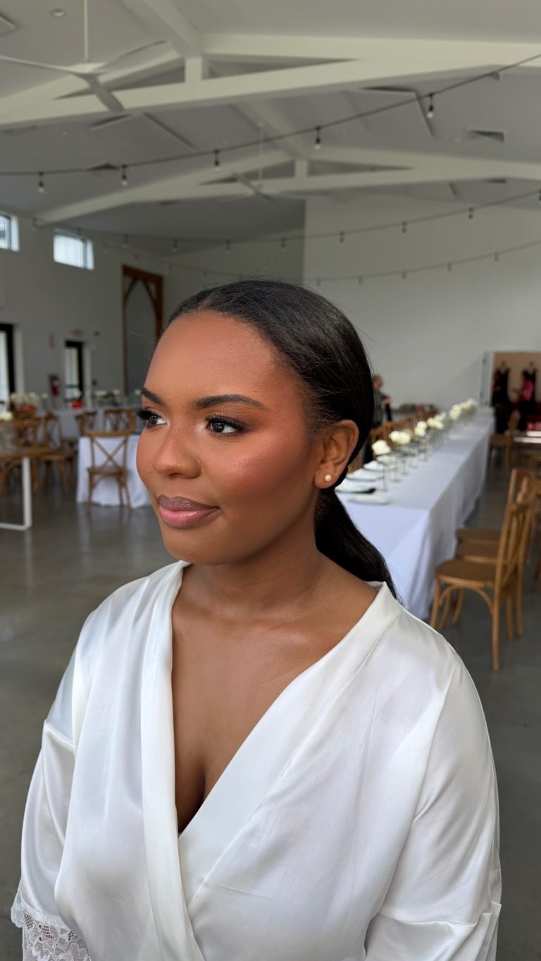 Natural bridal makeup with warm-toned eyeshadow, soft glow, and a sleek low ponytail hairstyle styled for a modern wedding day.