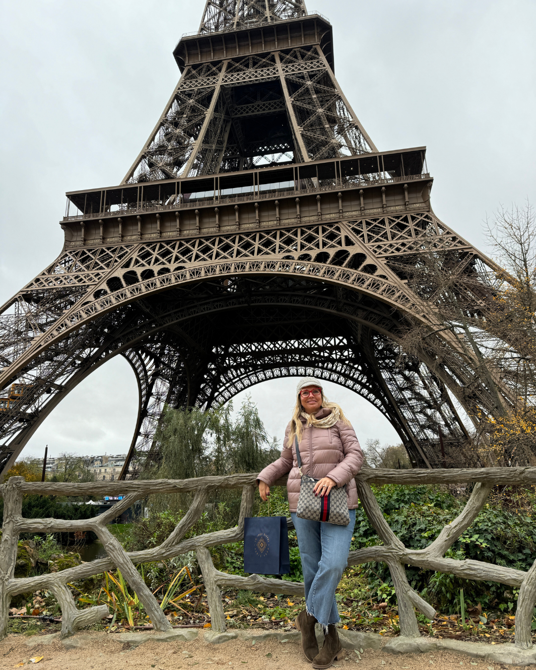 Travel agent posing in front of the Eiffel Tower in Paris during autumn