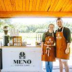 Wedding beverage vendors operating Meno Coffee Cart under wooden pavilion