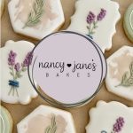 Decorated sugar cookies featuring lavender and rosemary designs surrounding Nancy Jane's Bakes logo