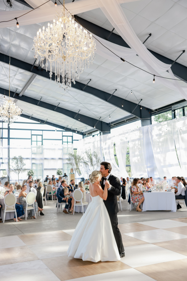 bride and groom dancing on a checkered dance floor inside the venue