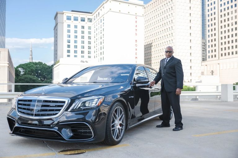 luxury transportation car with chauffer holding door